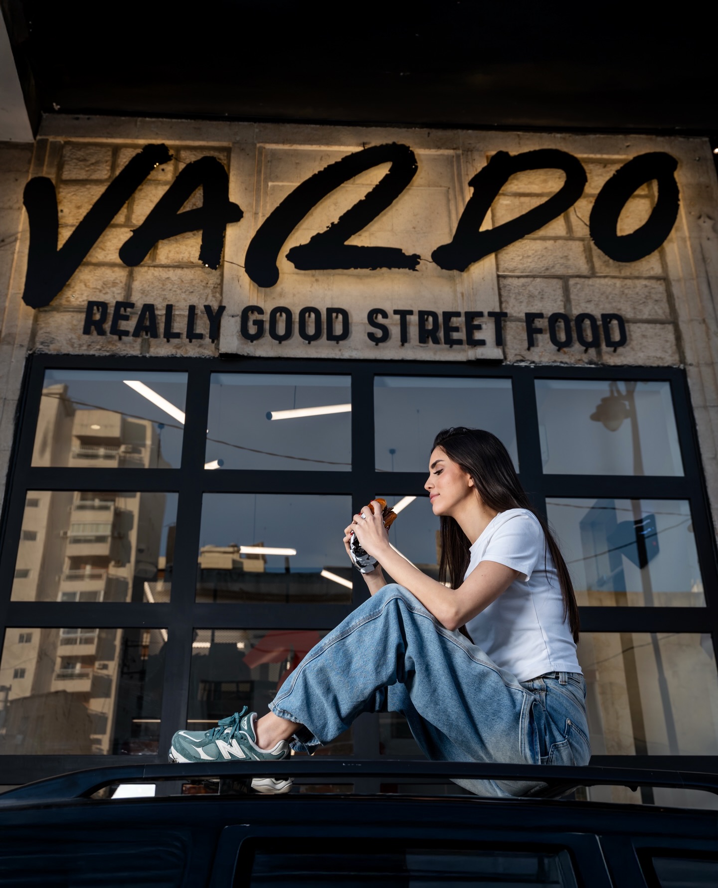 The Vardo storefront with a guest enjoying a burger out front